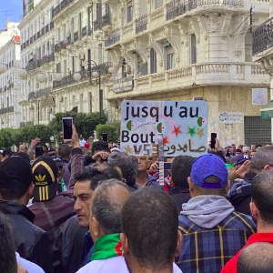 Algerians wrap up full-year of rallies with pledge to continue until old regime fallsF